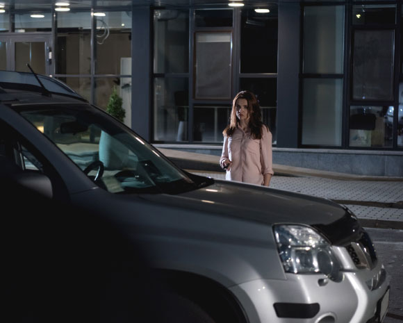 woman approaching her car at night